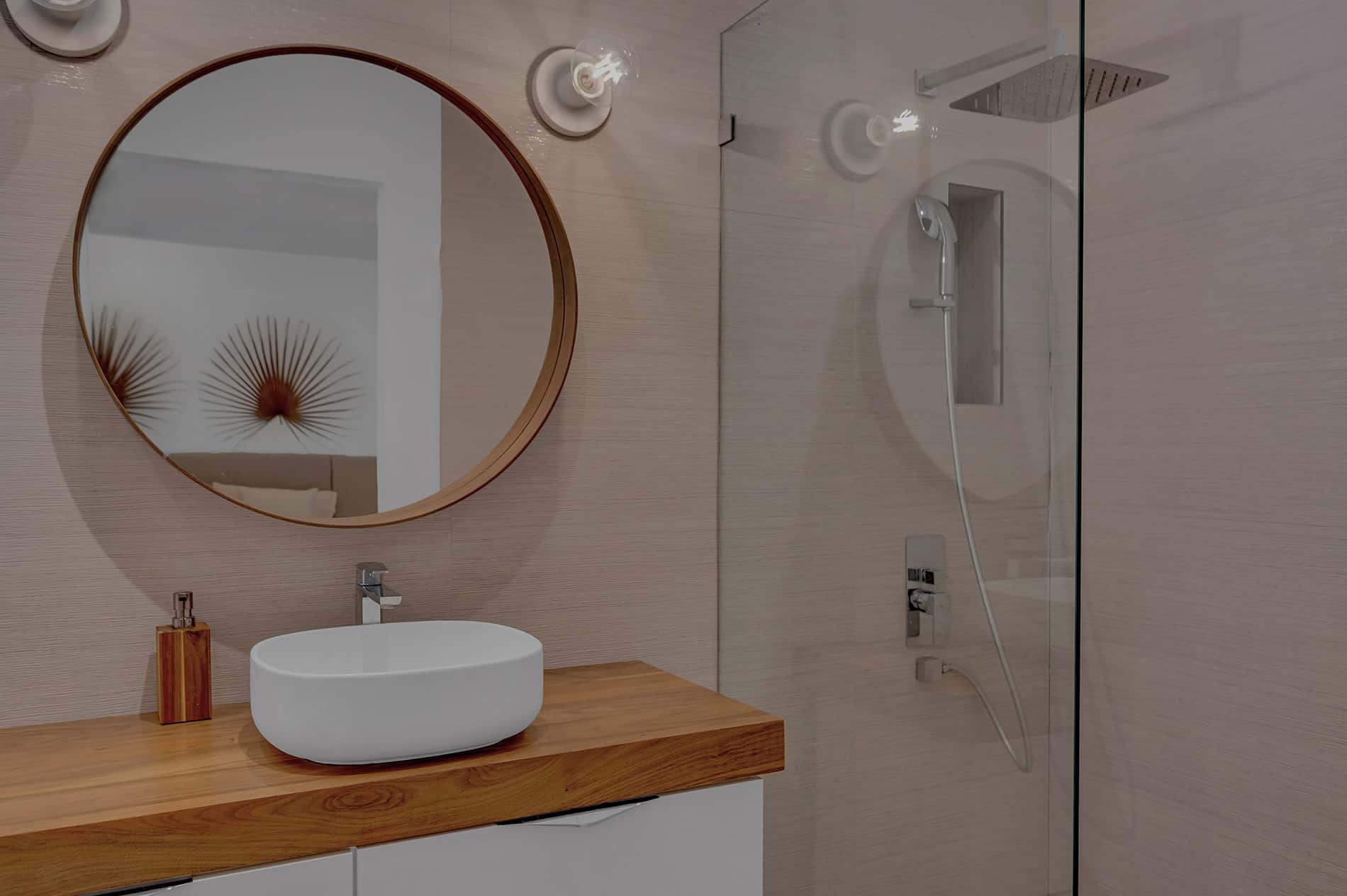 Coconut Grove home renovation - main bathroom with round mirror and glass shower door, designed by Beatrice Leupold Coconut Grove home renovation - main bathroom with round mirror and glass shower door, designed by Beatrice Leupold