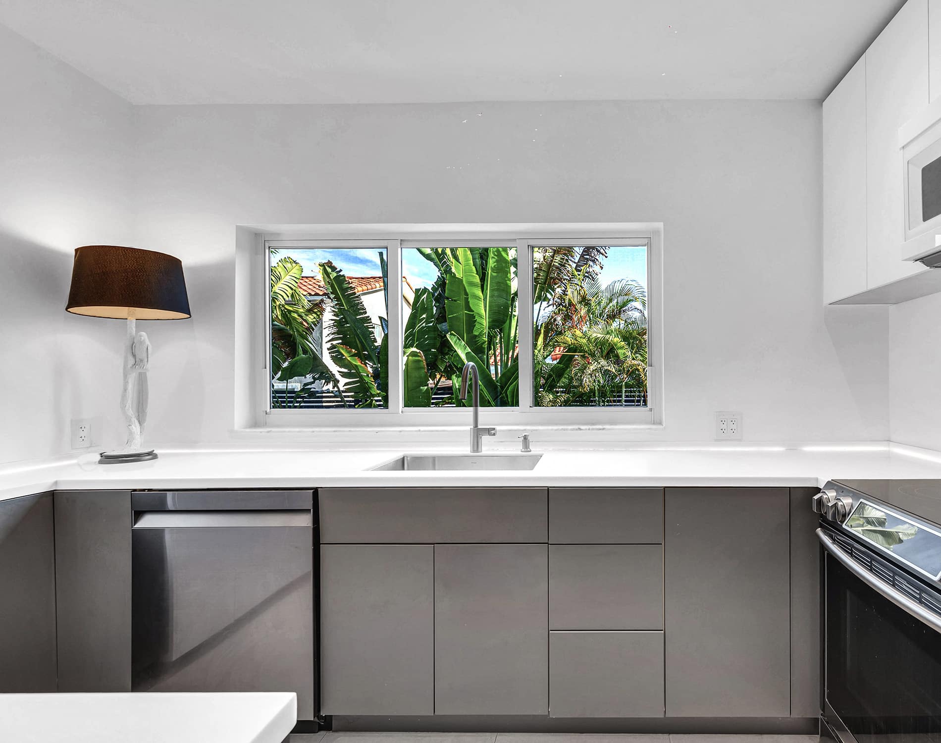 Coconut Grove home renovation - kitchen sink with window, designed by Beatrice Leupold Coconut Grove home renovation - kitchen sink with window, designed by Beatrice Leupold